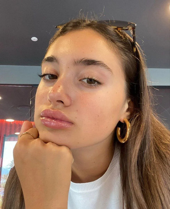Customer using PDRN Peptide Glossy Lip Balm